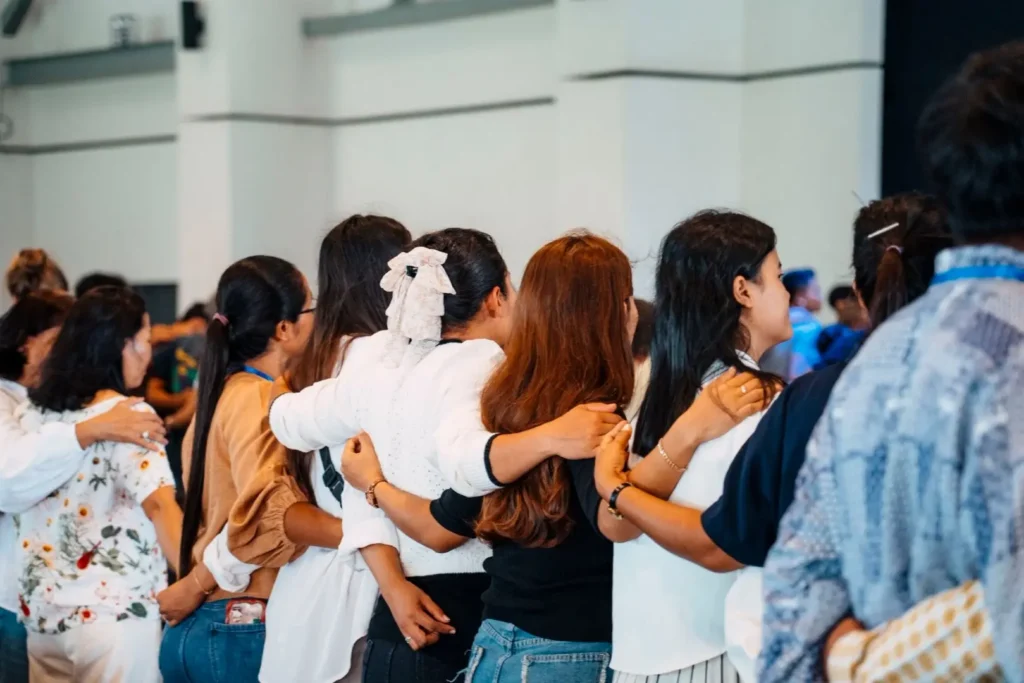 Photo of people on campus supporting each other