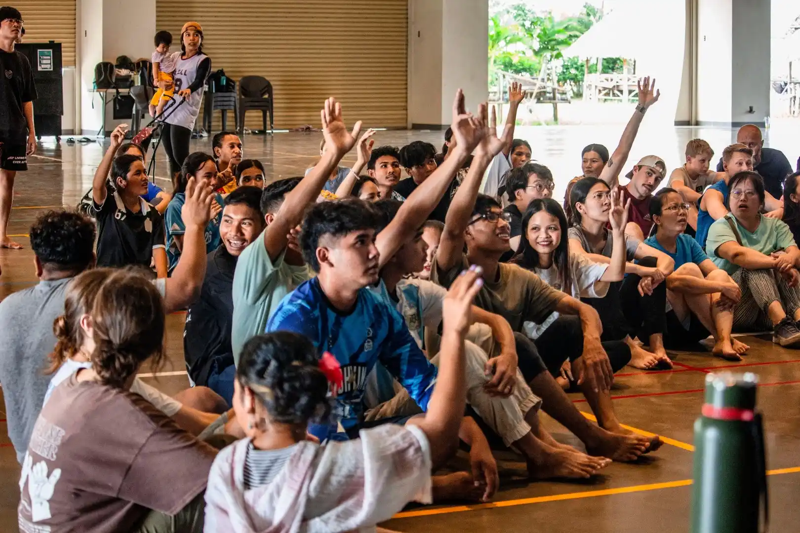 Photo of staff and students with their hands up